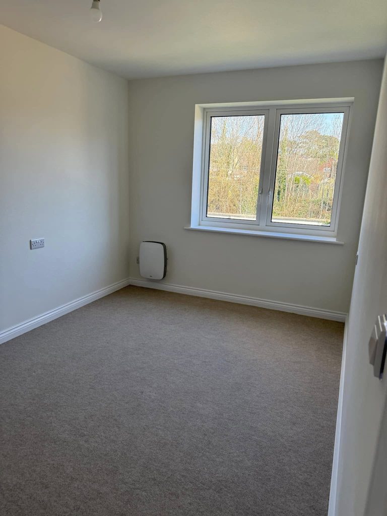 Clean carpeted bedroom after professional carpet cleaning