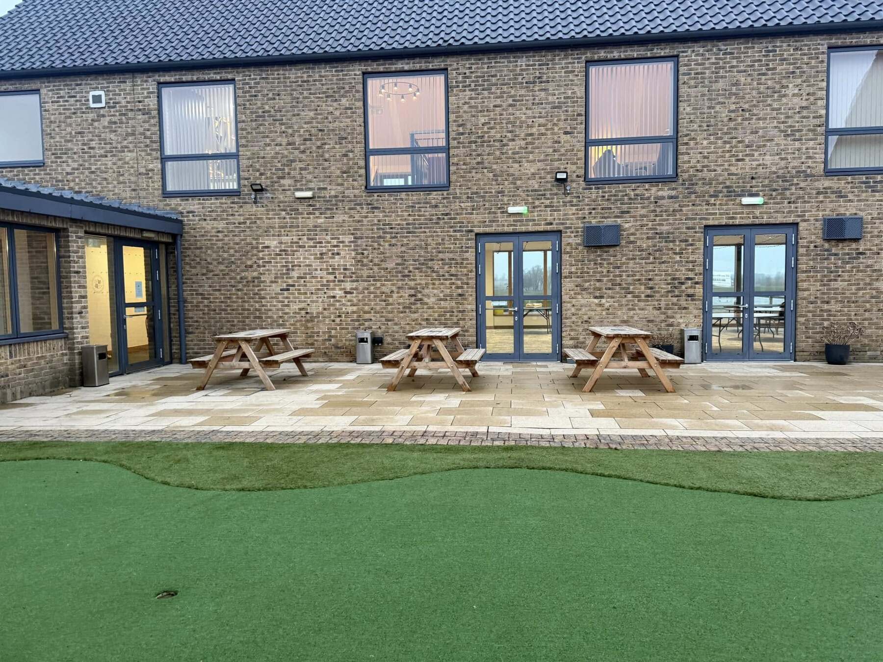 Clean paved patio outside a brick building